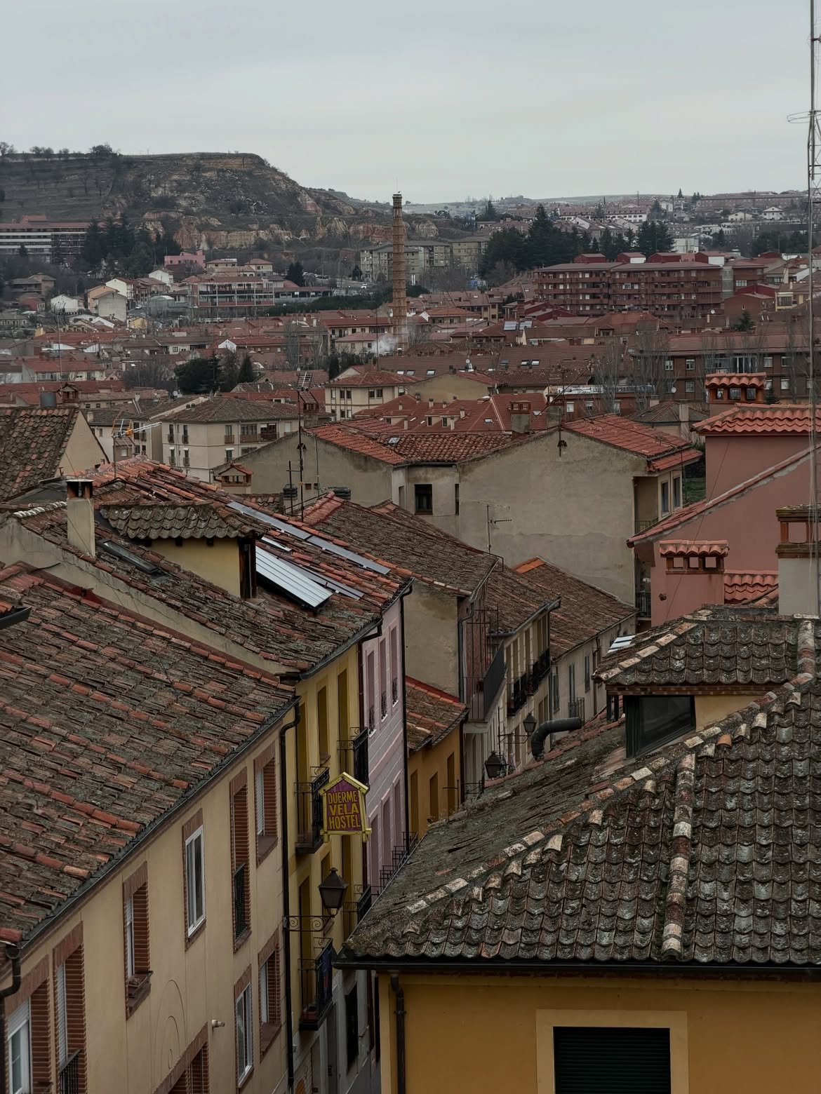 Segovia rooftops and tiled roofs under grey sky