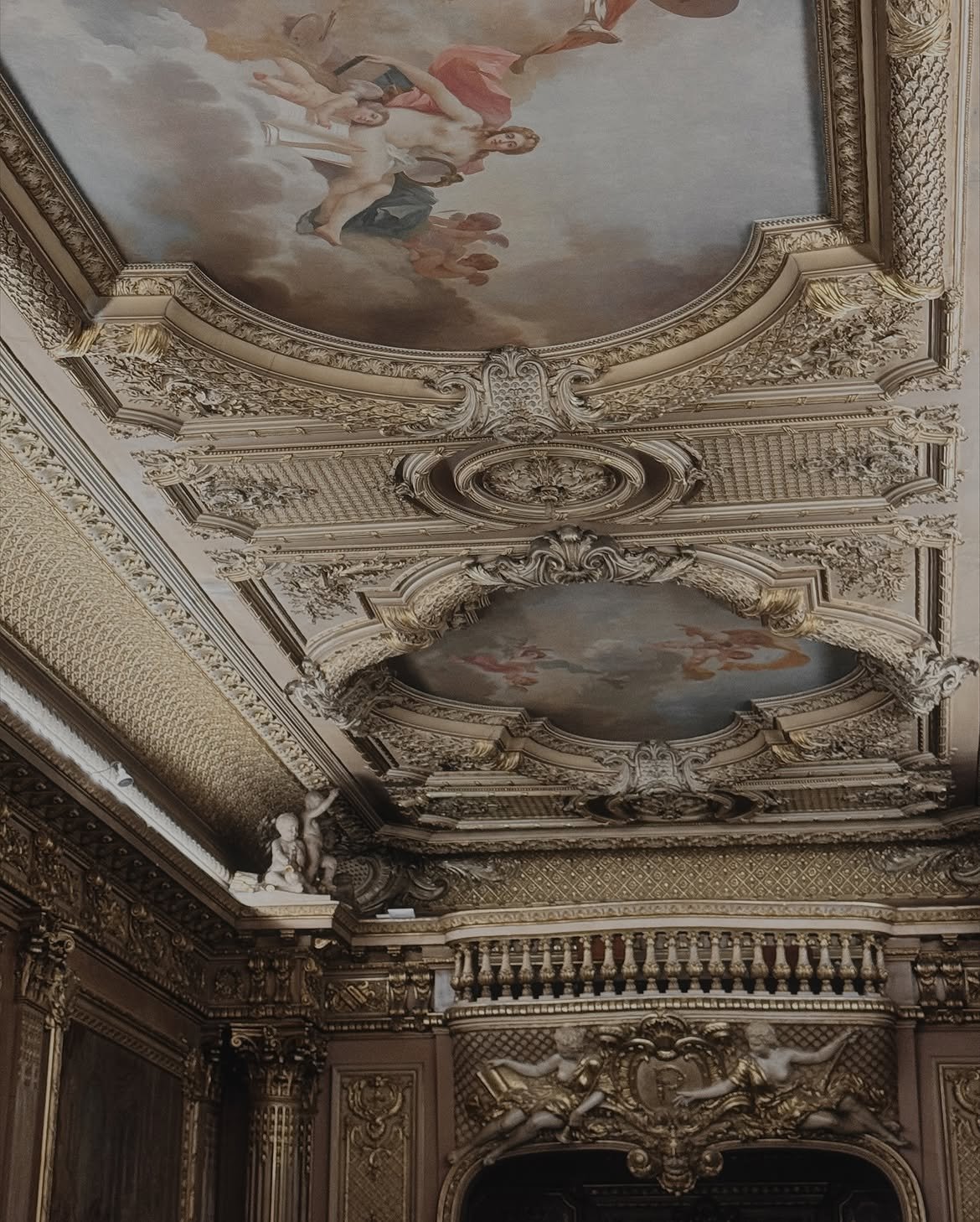 Gilded ceiling with painted frescoes and carved cherubs