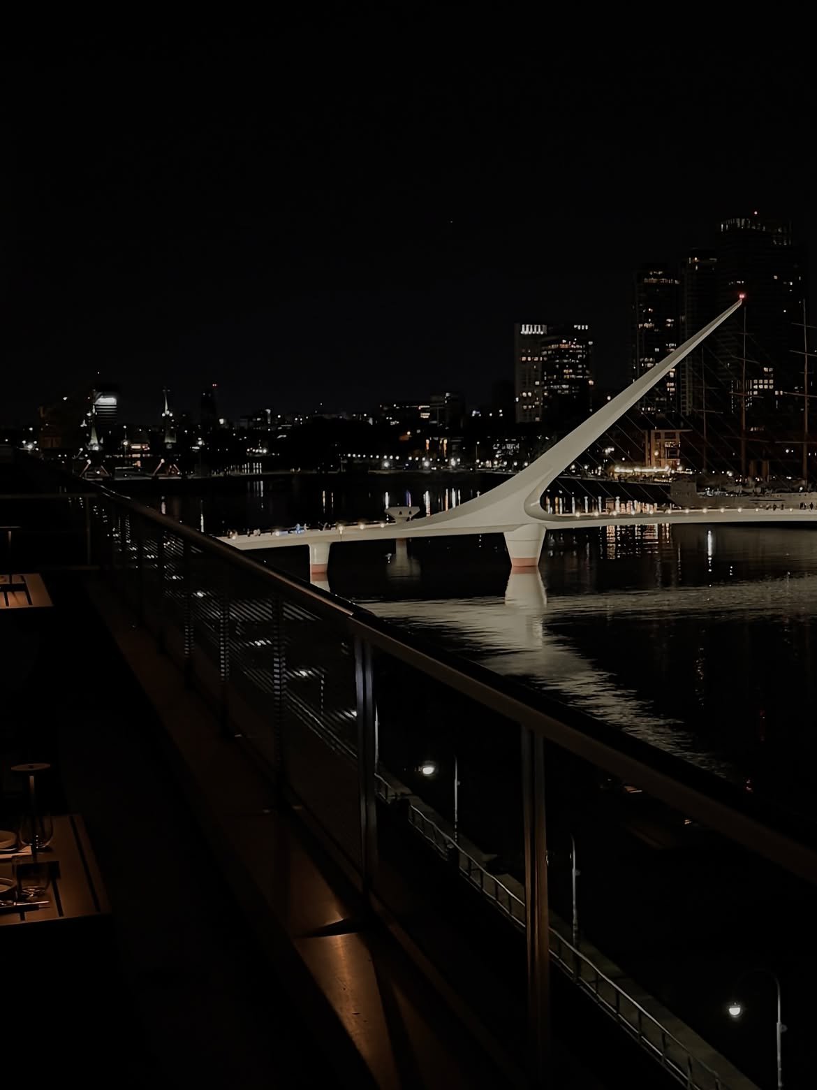 Puente de la Mujer lit at night over the Puerto Madero dock